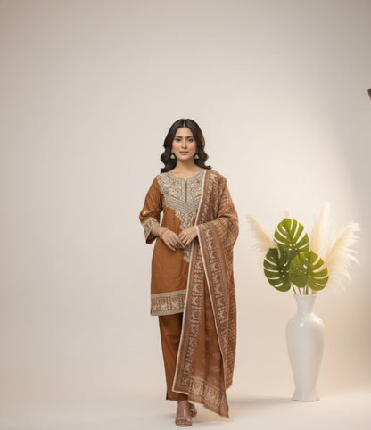 Woman in a traditional outfit standing next to a white vase with green leaves on a plain background