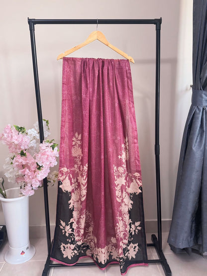 Pink floral skirt on a hanger against a neutral background