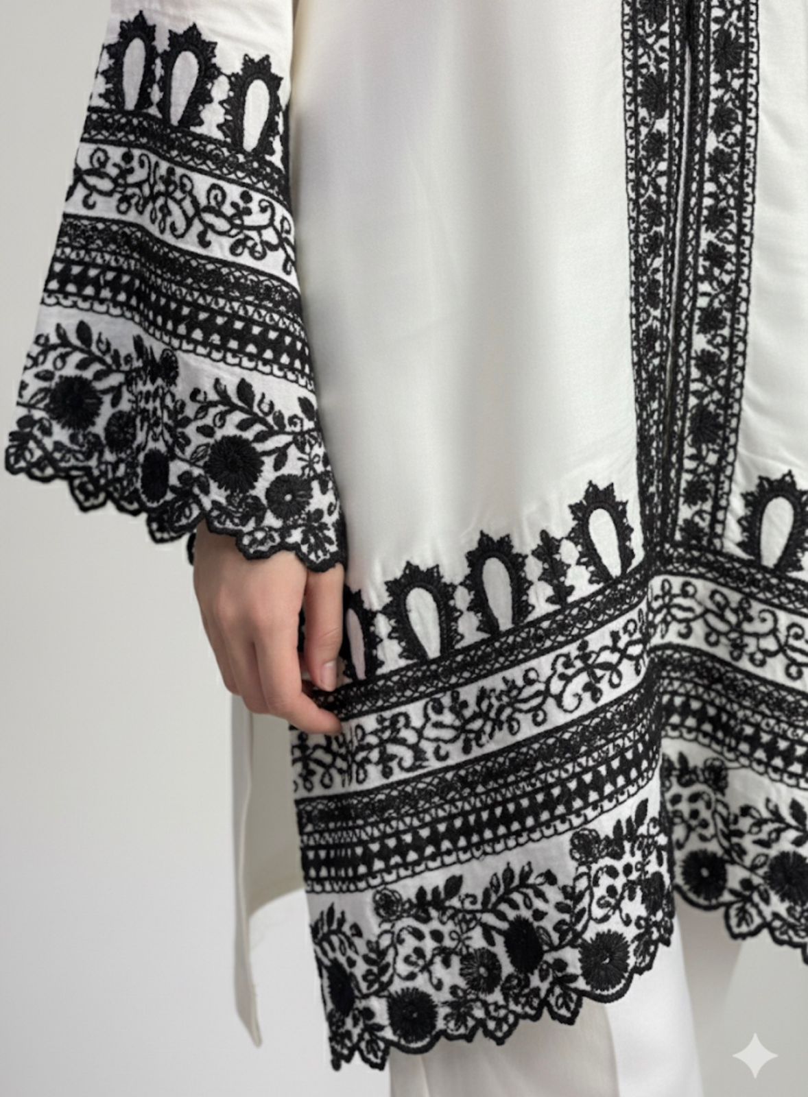 White dress with black intricate patterns on a white background