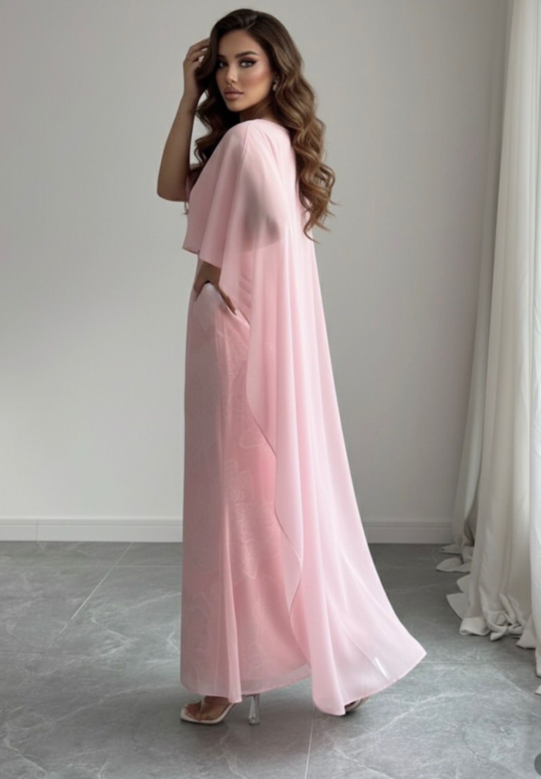 Woman wearing a pink dress standing in a room with a neutral background
