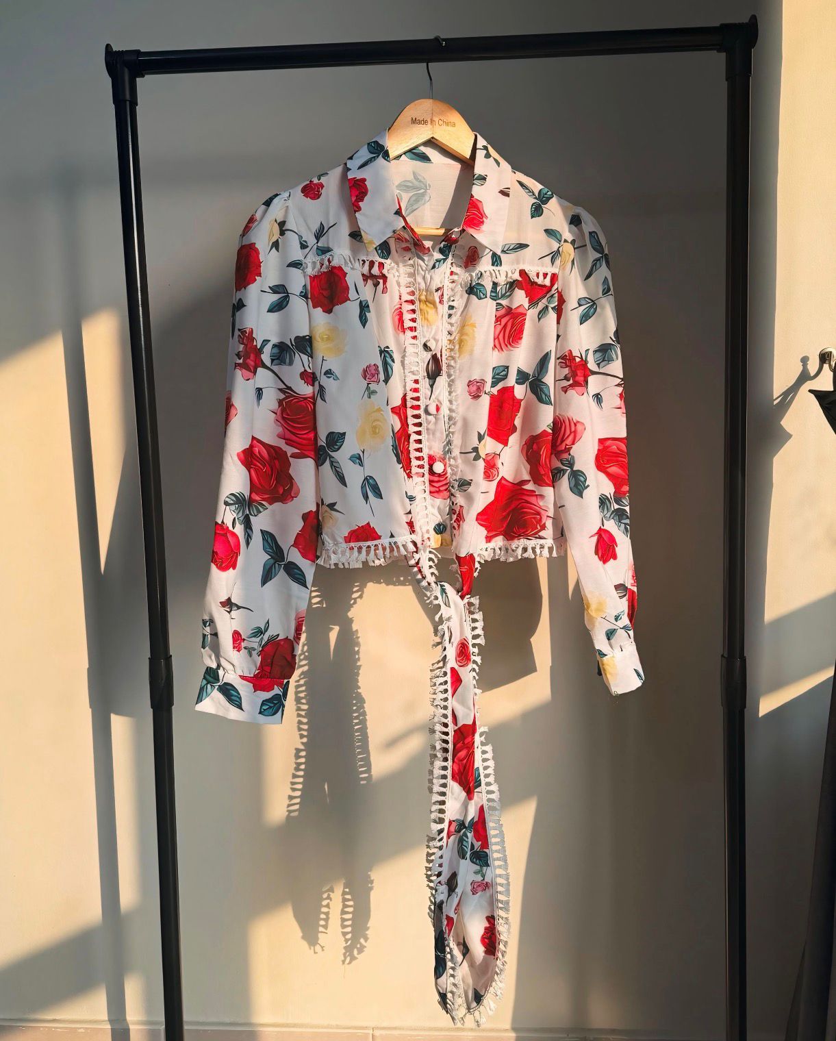 Floral-patterned outfit on a hanger against a neutral background